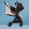 Jet 5 Almond Travel Stroller with car seat on it