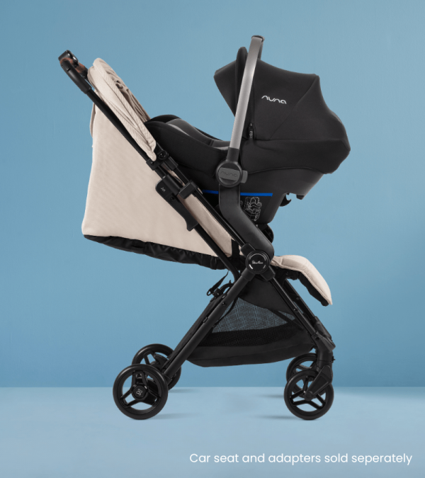 Jet 5 Almond Travel Stroller with car seat on it